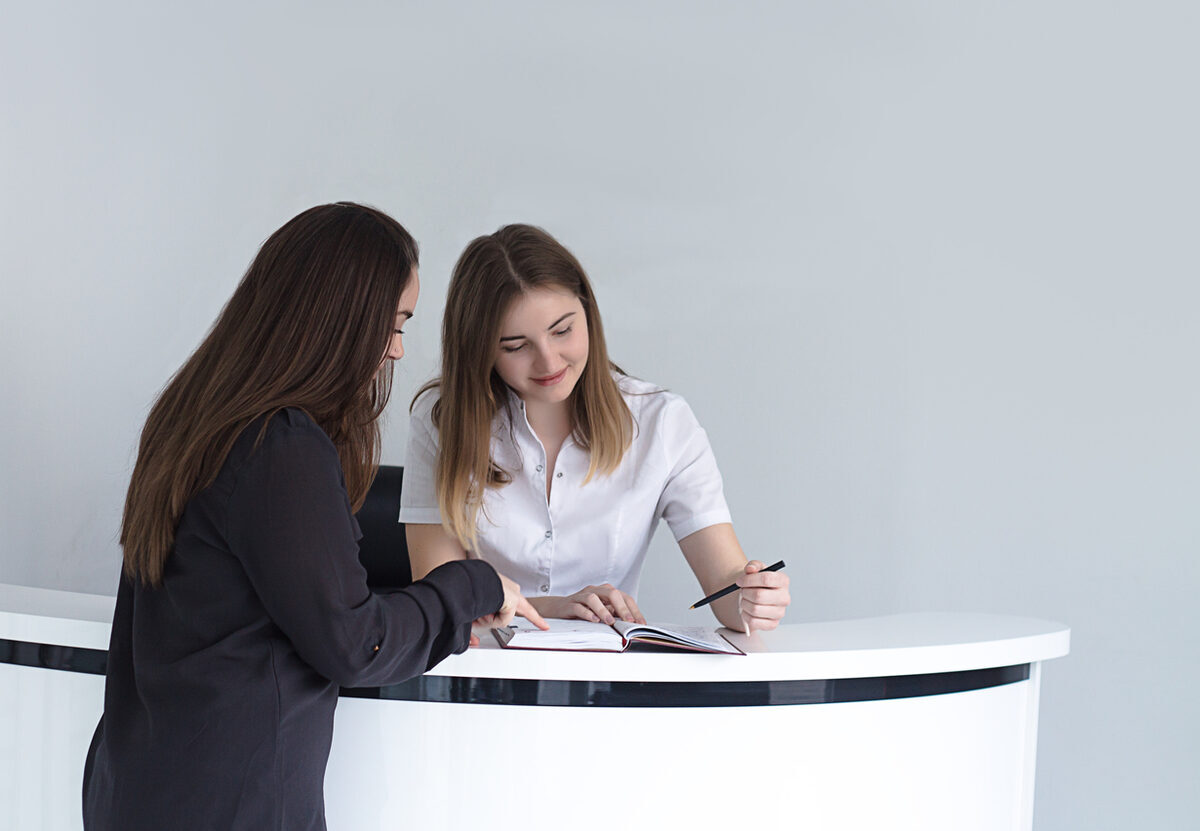 A patient checking in at a practice front desk
